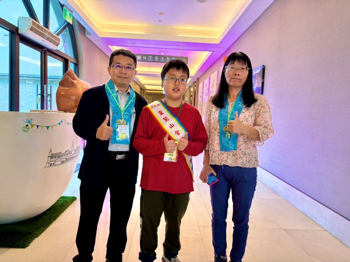 《圖說》台南市宅港國小的周君憲，與校長林維智、教導主任陳美惠合影。（靈鷲山佛教教團提供）